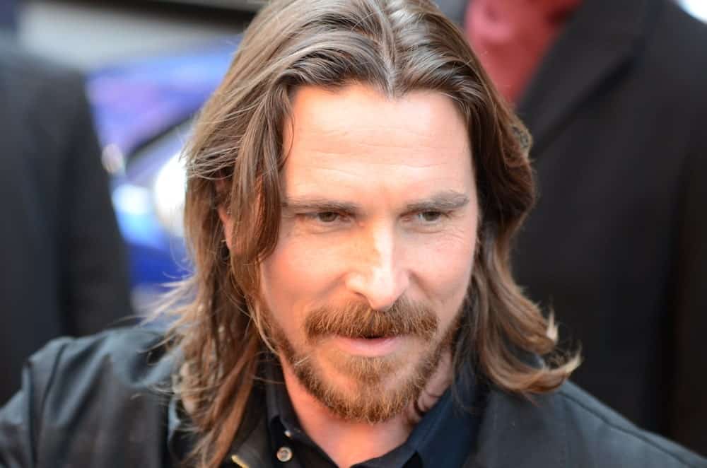 Christian Bale is one of those people who look good regardless of what they do with their hair or face. Here, he is with his hair going all the way to his shoulders with a neat parting in the middle. His hair is a very nice, light shade of brown that looks really amazing with this length of hair.