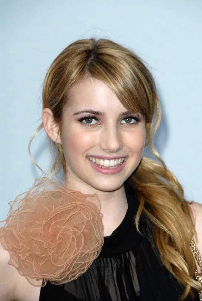 Emma Roberts attended the 2007/2008 Chanel Cruise Show Presented by Karl Lagerfeld at Hangar 8, Santa Monica, CA on May 18, 2007. She wore a lovely black dress with her low ponytail brunette hairstyle with long side-swept bangs.