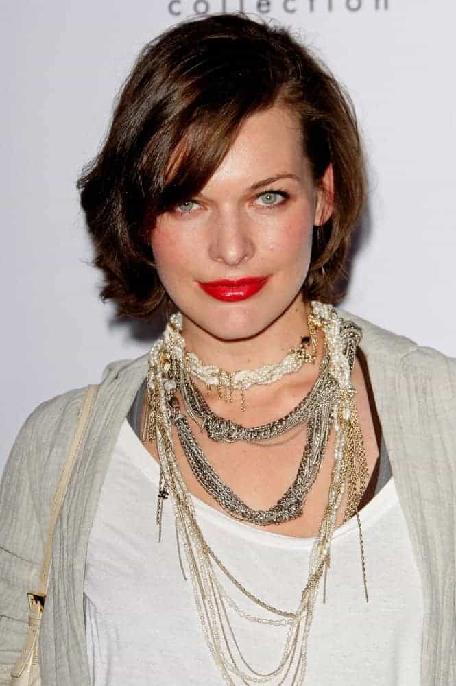 Milla Jovovich was at the Calvin Klein Collection & Los Angeles Nomadic Division 1st Annual Celebration on January 28, 2010, in Los Angeles, California. She was seen wearing a fashionable casual outfit with her chin-length brunette hairstyle with side-swept bangs.