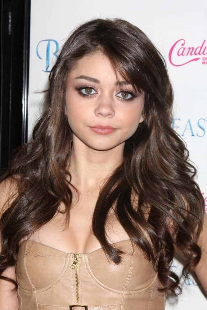 Sarah Hyland was at the "Beastly" Premiere at Pacific Theaters at The Grove on February 24, 2011, in Los Angeles, CA. She was charming in her strapless leather dress, simple makeup, and long tousled wavy hair with layers and highlights.