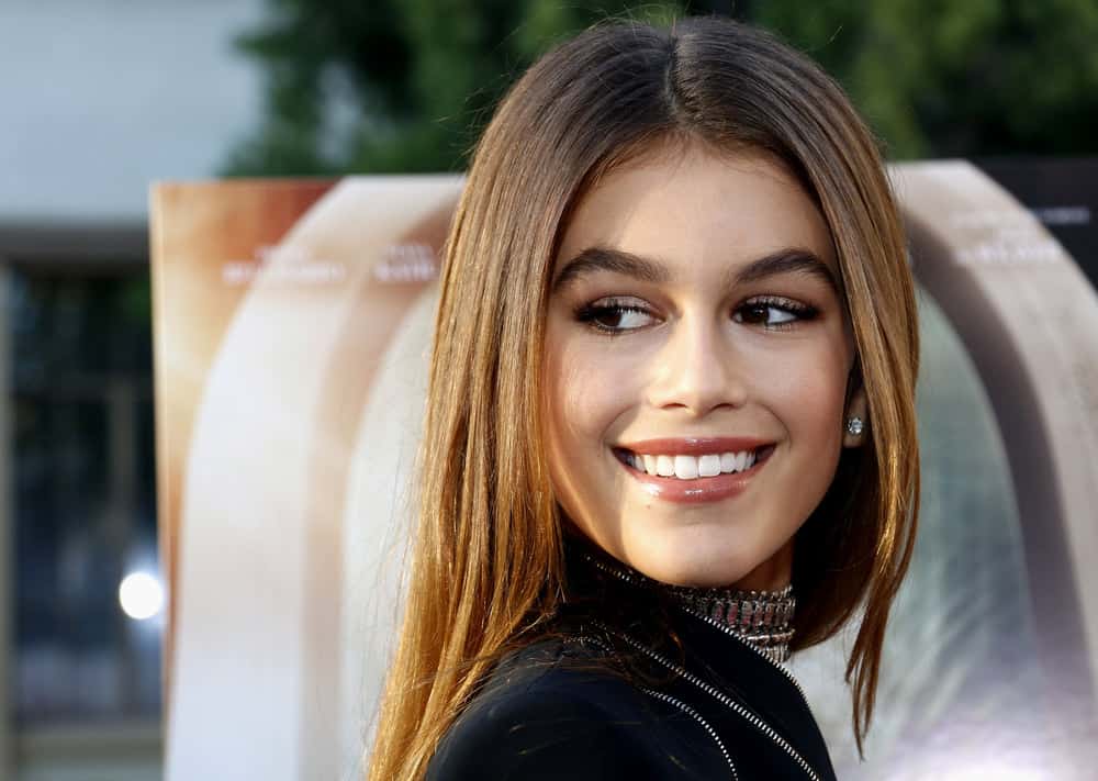 Kaia Gerber with straight long hair middle part
