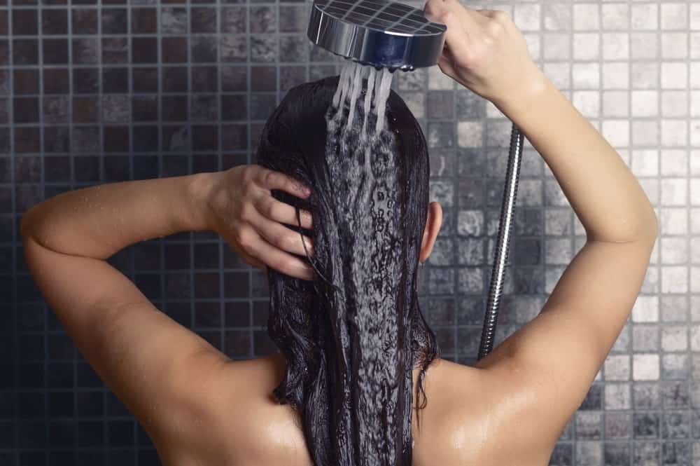 Woman rinsing out conditioner