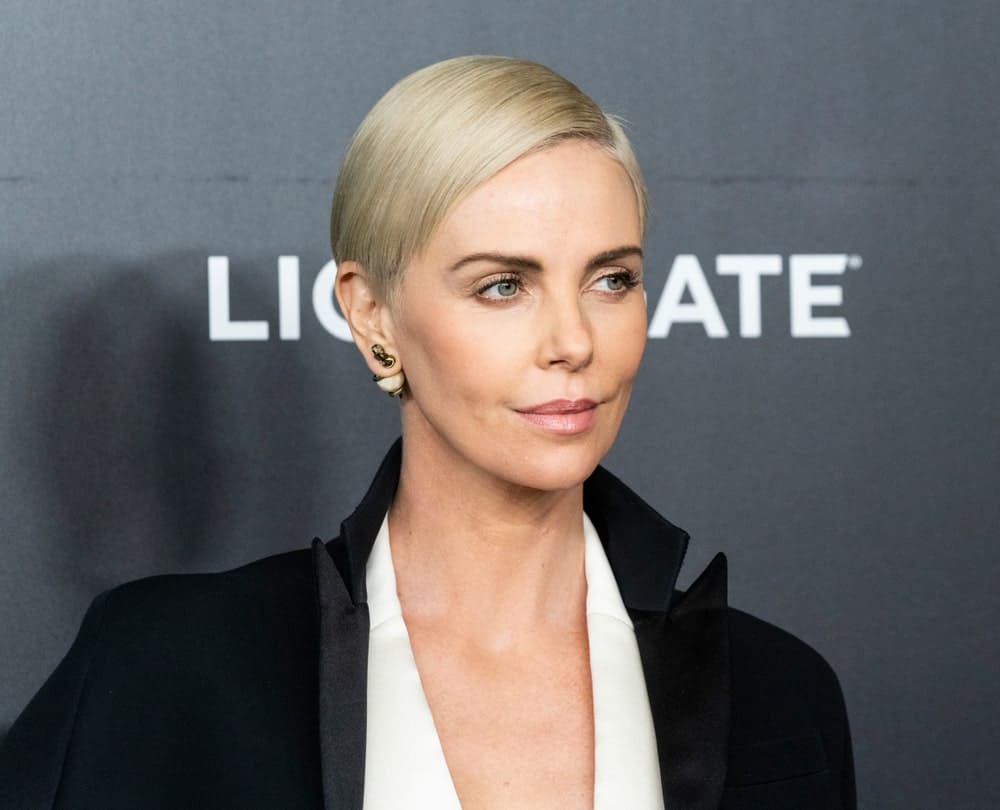 Charlize Theron flawlessly flaunts her sleek pixie blonde hair on a side-sw...