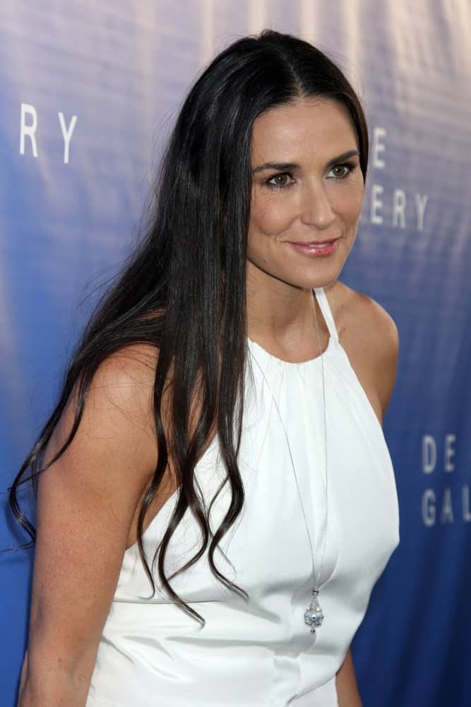 Demi Moore rocks in a white halter dress that's paired with a long necklace along with her black tousled hair partially permed with subtle waves. This look was worn during the De Re Gallery Opening last May 15, 2014.