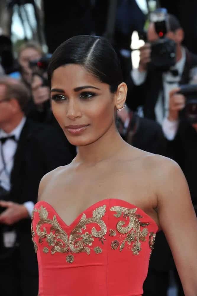 The actress paired her bright and elegant gown with this neat and slick side-parted updo at the gala premiere of “The Homesman” at the 67th Festival de Cannes, May 18, 2014.