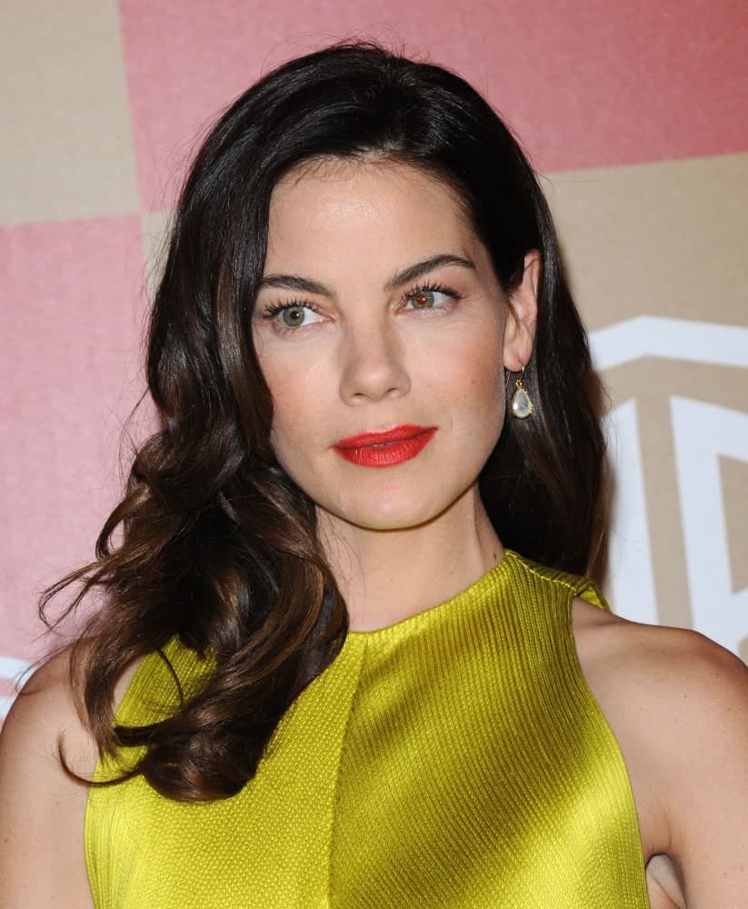 Michelle Monaghan arrives at the In Style Golden Globe Party on January 13, 2013 in Hollywood wearing a golden outfit that perfectly complements her side-swept dark curls with subtle highlights for a bit of depth.