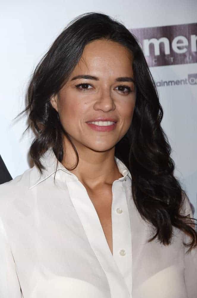 Back in February 2015, Michelle Rodriguez had long straight raven hair that was styled into this wavy and tousled masterpiece contrasting her white sheer blouse.