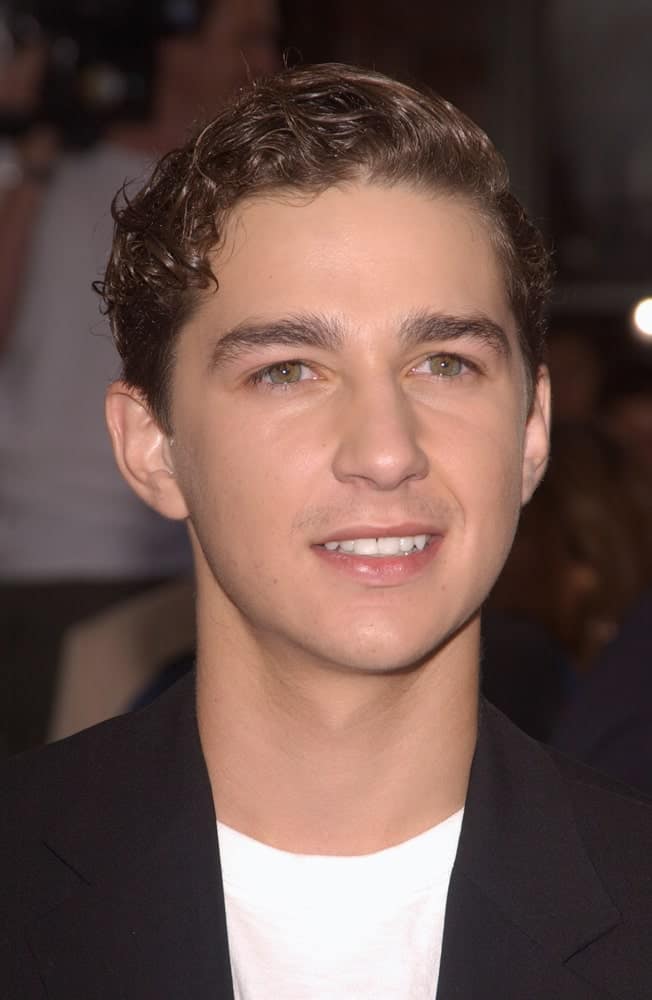 The actor had his short curly hair into an elegant side-parted sleek finish at the world premiere, in Los Angeles, of his new movie I, Robot last July 7, 2004. He matched this with a simple black suit and white shirt.