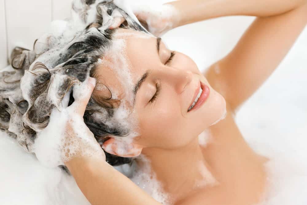 Woman shampooing her hair.
