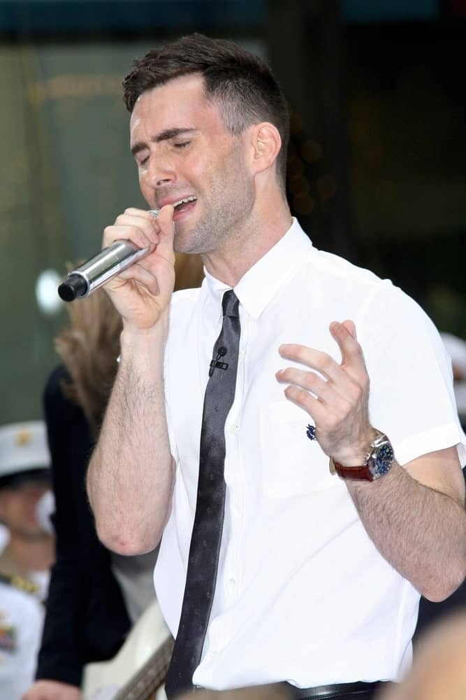Adam Levine was on stage for NBC Today Show Concert with Maroon 5 held at the Rockefeller Center in New York on May 28, 2007. Levine paired his neat five o’clock shadow with a fade crew cut side parted hairstyle.