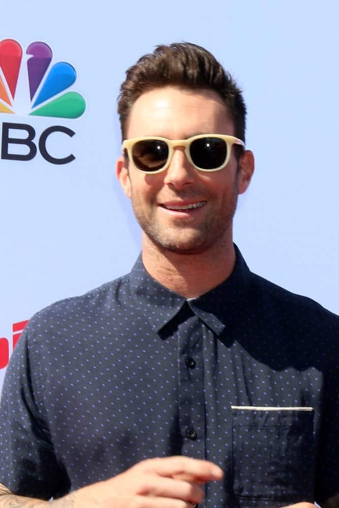 Adam Levine looked hip and handsome with his sunglasses and side-swept pompadour hairstyle that complemented his button-down shirt at the The Voice Red Carpet Event at the Hyde on April 21, 2016 in Los Angeles, CA.