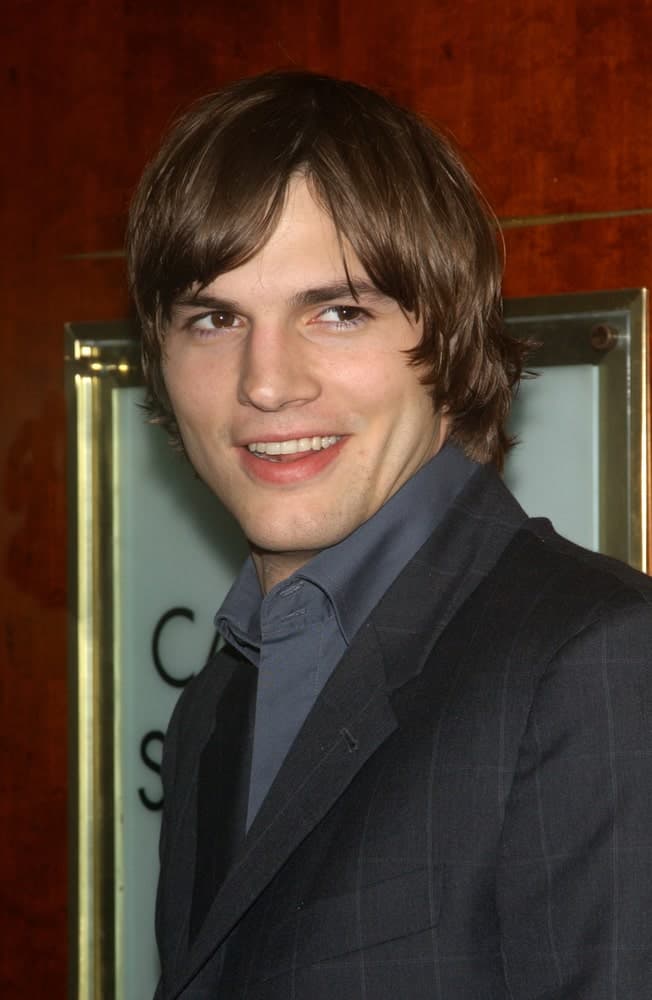 Actor Ashton Kutcher's long and layered dark brown hair was side parted at the 65th Annual Will Rogers Pioneer of the Year Dinner honoring Walt Disney CEO Michael Eisner on December 4, 2003.