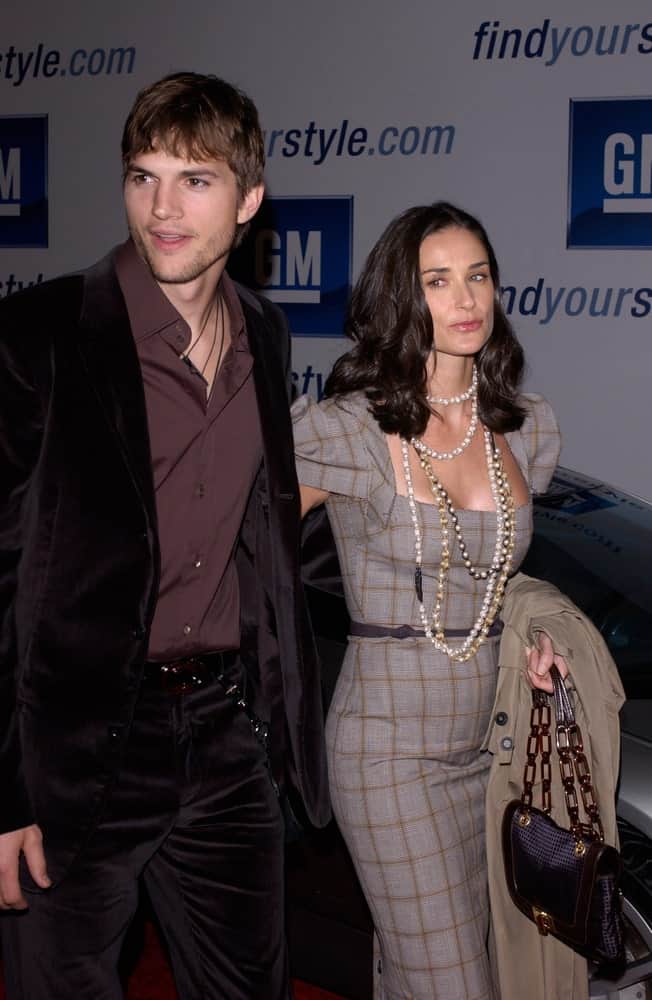 On February 22, 2005 in Los Angeles, Demi Moore & Ashton Kutcher were at the General Motors 4th Annual "ten" fashion show. The pair looked beautiful in stylish clothes with Kutcher topping it off with a short fringe hairstyle.