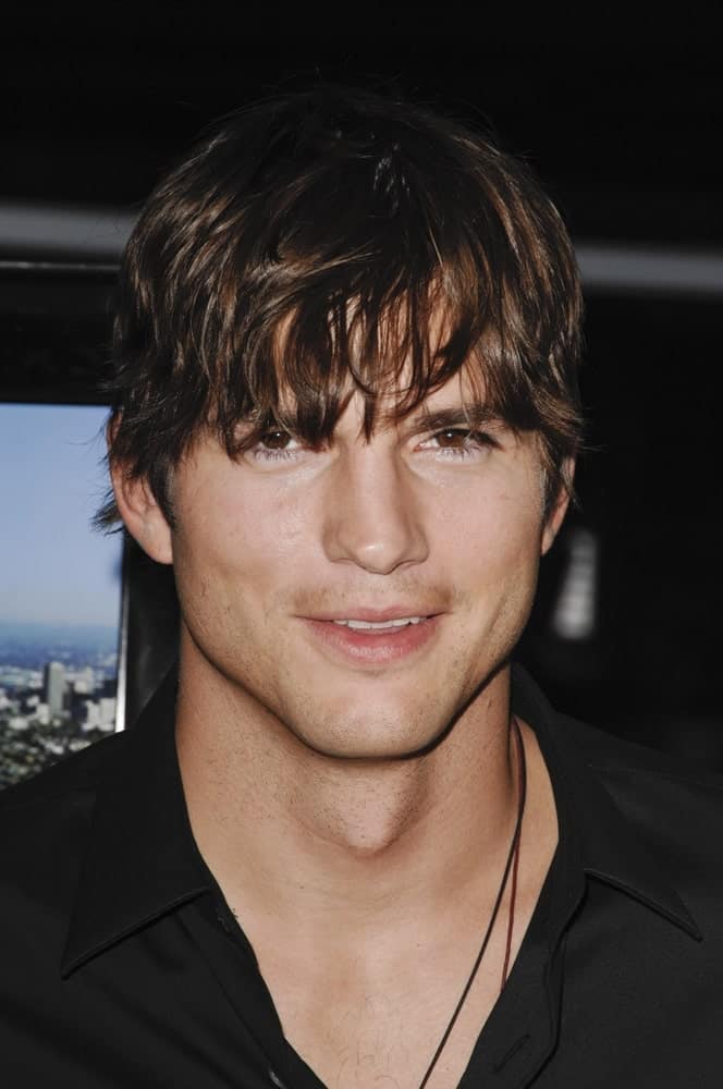 Ashton Kutcher's eye curtain bangs and highlighted fringe hairstyle was paired with his black button-down shirt at the SPREAD Premiere, ArcLight Cinemas Hollywood in Los Angeles, CA on August 3, 2009.