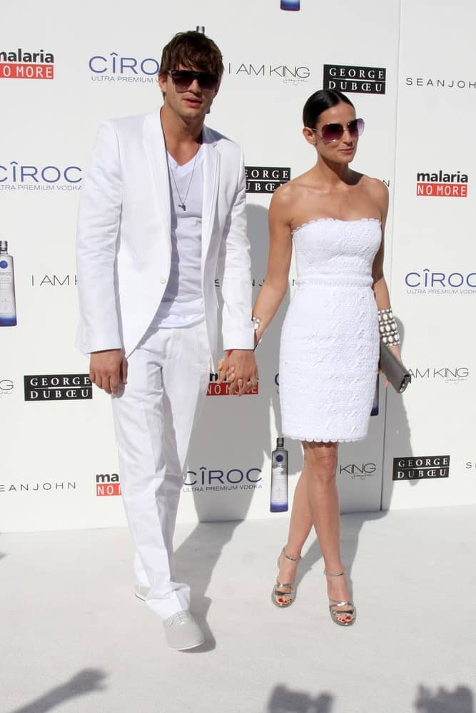 Ashton Kutcher & Demi Moore attended the White Party hosted by Sean "Diddy" Combs & Ashton Kutcher in Beverly Hills, CA on July 4, 2009. Kutcher's all-white smart casual outfit went well with his side-parted fringe hairstyle.