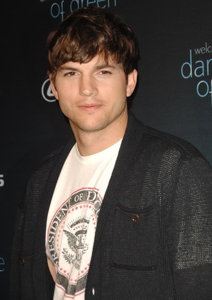 Ashton Kutcher wore a casual shirt and sweater jacket at "The Dark Side of Green" Debate, Palihouse Holloway in West Hollywood on July 8, 2010. He paired this with a highlighted fringe hairstyle that has a slight tousled finish.