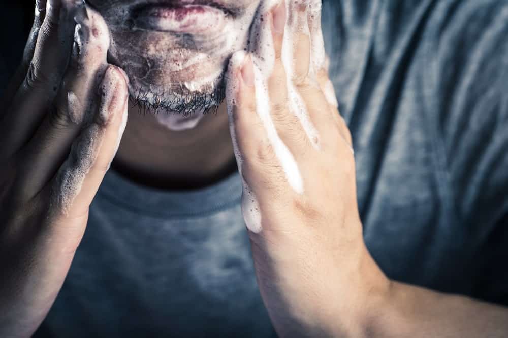 Man washing his beard.