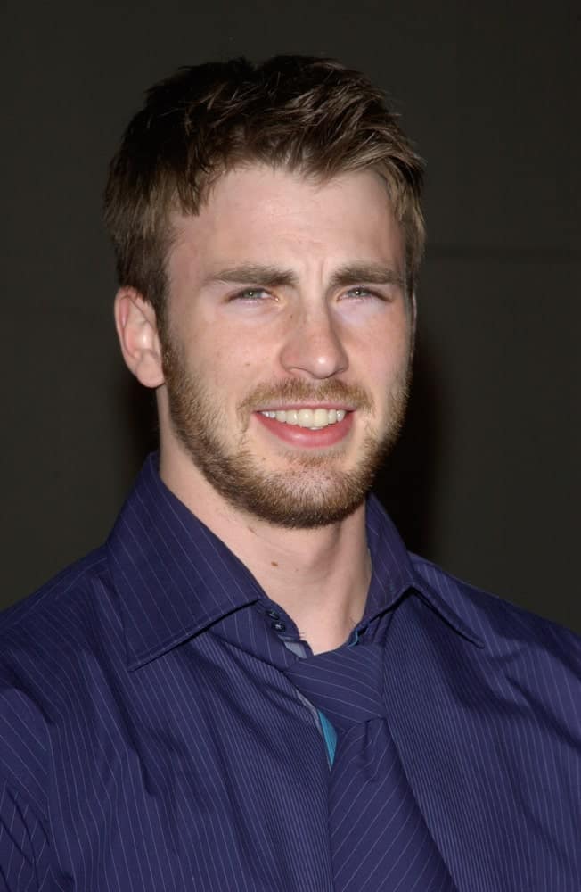 Actor Chris Evans wore a blue button-down shirt with his tousled and spiked fade hairstyle at the world premiere of his new movie "The Perfect Score" on January 27, 2004 in Hollywood.