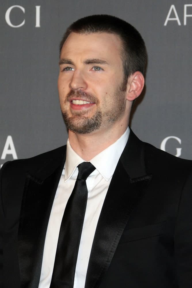 Chris Evans attended the LACMA 2012 Art + Film Gala at Los Angeles County Musem of Art on October 27, 2012 in Los Angeles, CA. He wore a black suit to go with his buzz cut hairstyle and goatee.