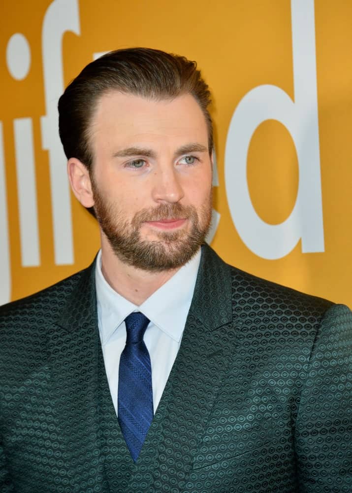 On April 4, 2017, Actor Chris Evans wore a beautiful patterned three piece suit that he paired with his slicked back hairstyle at the premiere for "Gifted" at The Grove.