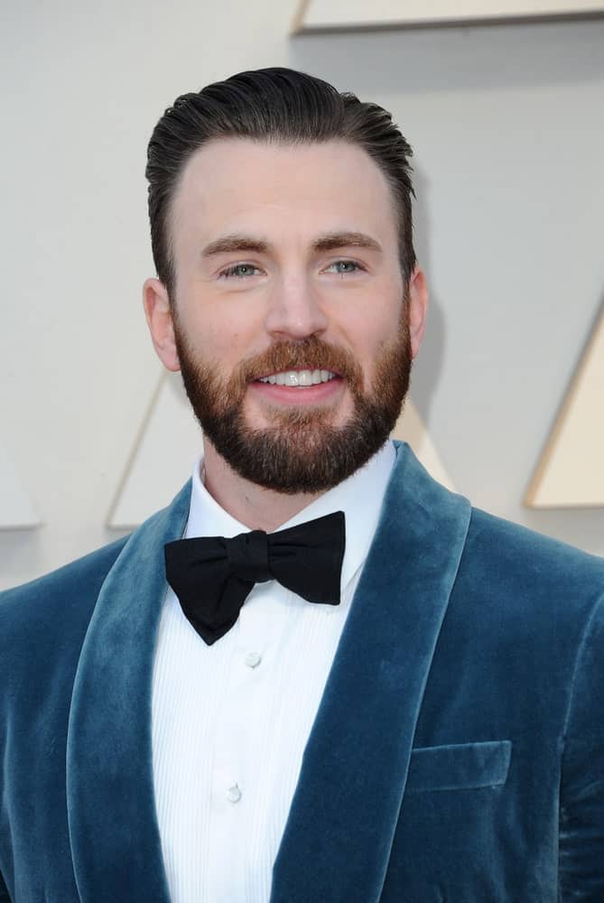 Chris Evans wore a blue velvet suit with his vintage slicked back hairstyle at the 91st Annual Academy Awards held at the Hollywood and Highland in Los Angeles on February 24, 2019.