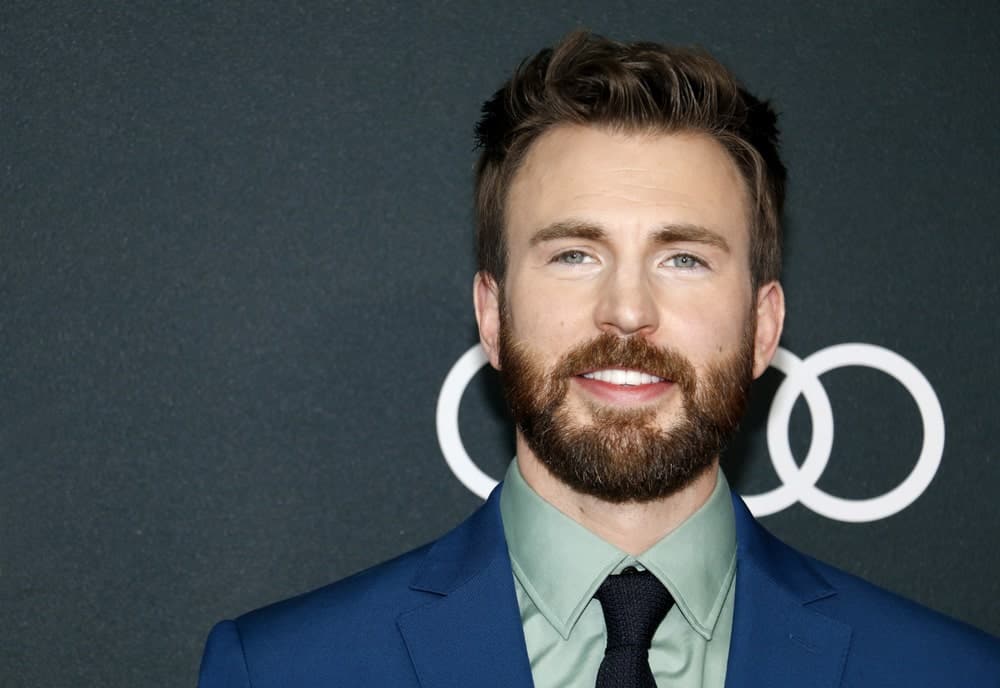 Chris Evans was at the World premiere of ‘Avengers: Endgame’ held at the LA Convention Center in Los Angeles on April 22, 2019. He wore a classy blue suit with his full beard and brushed up fade pompadour hairstyle.
