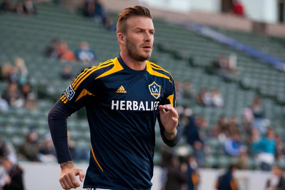 David Beckham warming up before the MLS game between the Los Angeles Galaxy and the Portland Timbers on April 14, 2012. He cut his hair with a neat undercut and styled it with a front brushed up.