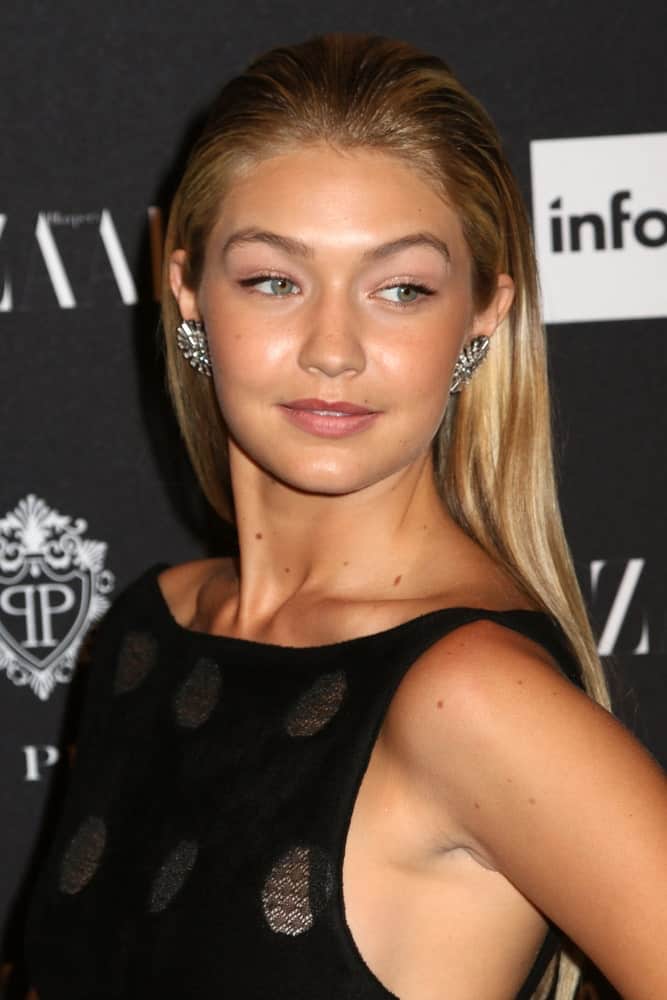 Gigi Hadid's lovely black dress was a perfect pair for her slicked back long and straight hair with highlights at the Harper's Bazaar ICONS event at the Plaza Hotel on September 5, 2014 in New York City.