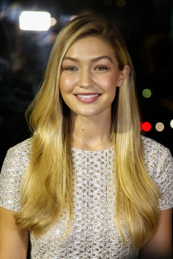 Model Gigi Hadid looked absolutely gorgeous and classy with her long and layered side-swept hairstyle with subtle highlights at the God's Love We Deliver, Golden Heart Awards on October 16, 2014 in New York City.
