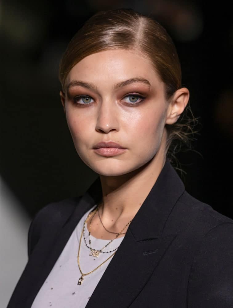 Gigi Hadid walked the runway during rehearsal for the Tom Ford 2019 Spring Summer fashion show during New York Fashion Week on September 5, 2018. Her hair was styled into a neat and slick low bun hairstyle.