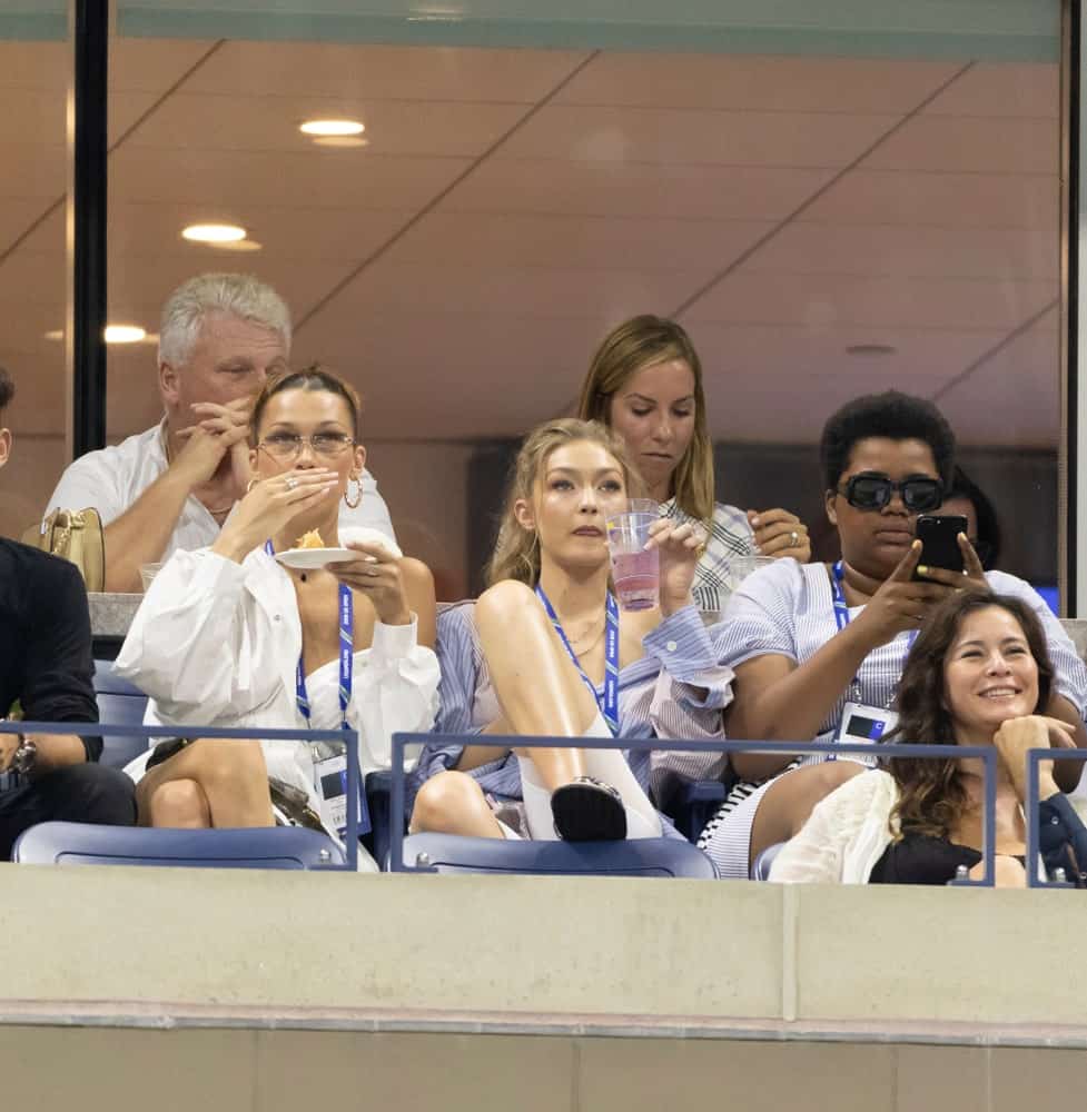 Bella Hadid and Gigi Hadid kicked back and relax at the US Open 2018 quarterfinal match at USTA Tennis Center. Gigi Hadid was seen with a loose button-down shirt and hair was in a loose and tousled ponytail.