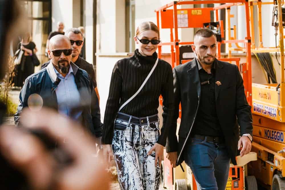 Gigi Hadid was seen before the Max Mara fashion show at Milan Fashion Week on September 20, 2018. She wore a casual long black sweater with her hair in a low bun hairstyle with a slick finish.