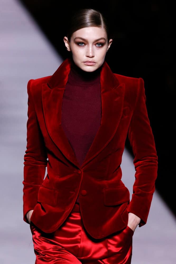 On February 06, 2019, Gigi Hadid walked the runway at Tom Ford Fall Winter 2019 Fashion Show at Park Avenue Armory in New York. She was dressed in a red velvet jacket with her hair in a slick low bun hairstyle.