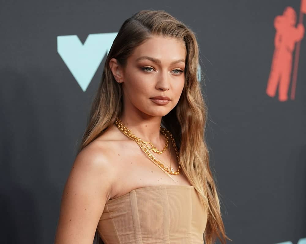 Gigi Hadid wore a fashionable flesh-colored corset outfit with her side-swept wavy hairstyle and simple make-up at the MTV Video Music Awards at the Prudential Center on August 26, 2019, in Newark, New Jersey.