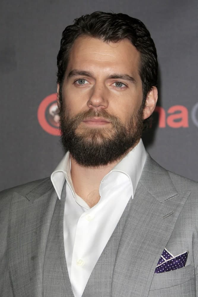 Henry Cavill arrived for the Warner Brothers 2015 Presentation at Cinemacon on April 21, 2015 with short gelled hair and a wild beard.