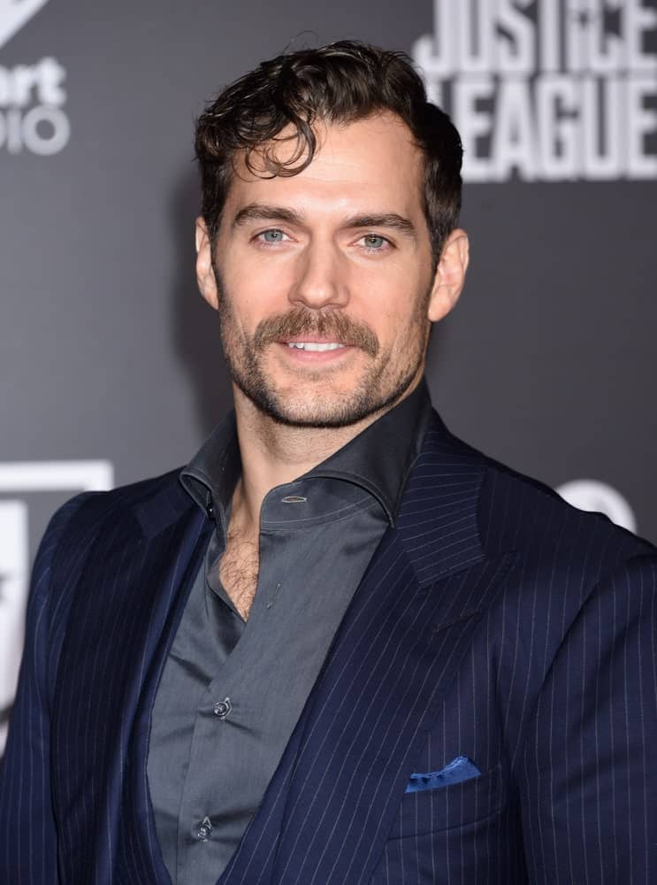 Henry Cavill sported a short wavy hairstyle incorporated with some curly bangs and a mustache at the "Justice League" World Premiere held last November 13, 2017.