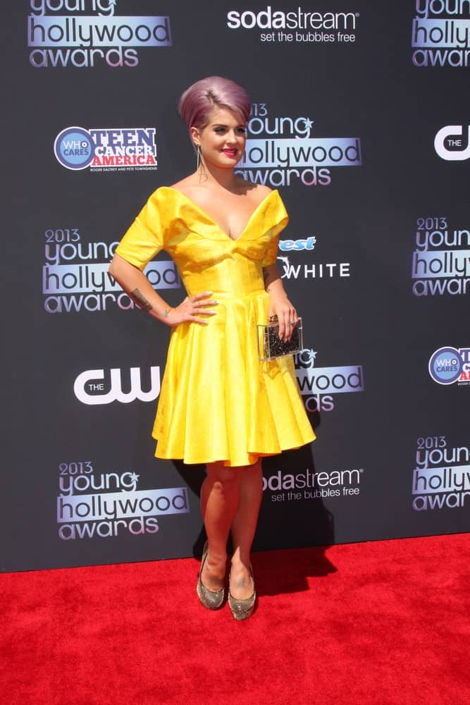 A youthful-looking Kelly Osbourne in a yellow dress. She looks so cute in the dress, which is perfect with her hairstyle. Photo taken on August 1, 2013.
