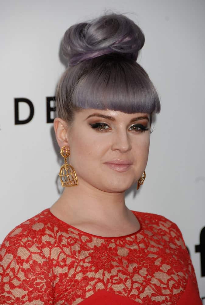 Kelly Osbourne seen wearing an elegant red dress along with her always staggering hairstyle. Photo was taken at the 4th Annual amfAR Inspiration Gala in Los Angeles, California on December 12, 2013.