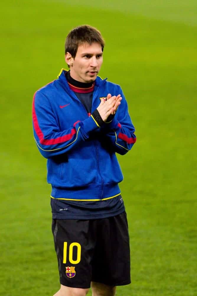 Lionel Messi of FC Barcelona warmed-up during the Spanish league match between RCD Espanyol and FC Barcelona on January 8, 2012, in Barcelona, Spain. He wore a jacket with his short Caesar hairstyle.
