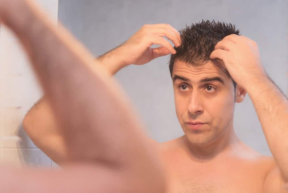 Man applying hair gel.
