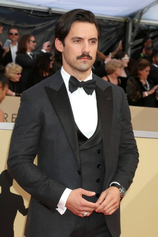 Milo Ventimiglia styled his wavy thick hair in a deep side part during the 24th Screen Actors Guild Awards - Press Room at Shrine Auditorium on January 21, 2018.