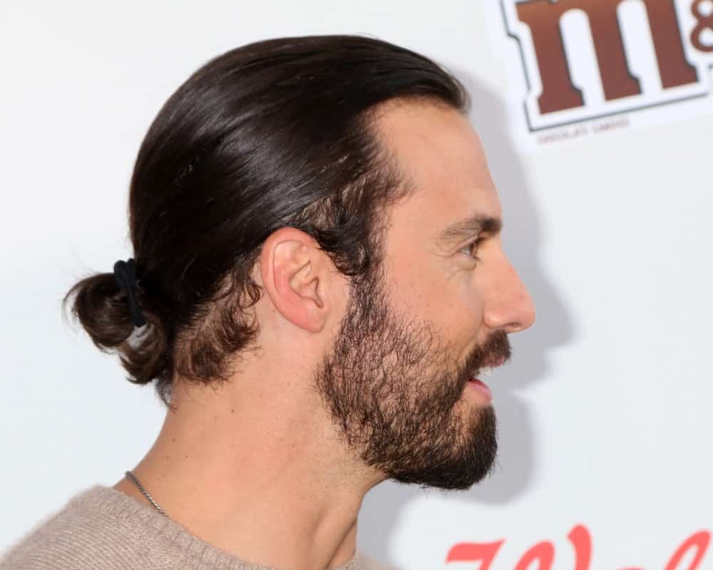 Milo Ventimiglia sporting a ponytail hairstyle at the Red Nose Day 2016 Special in Los Angeles, California.