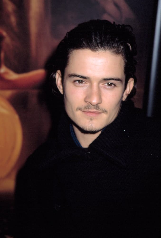 Orlando Bloom has thin trimmed beard that went quite well with his long dark curly hairstyle that was brushed back  into a slick finish at the 2002 premiere of "The Lord of the Rings: The Two Towers" in New York.