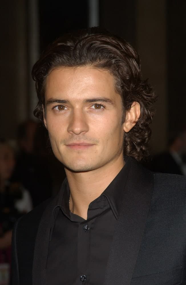 Actor Orlando Bloom was at the 2003 Hollywood Awards at the Beverly Hills Hilton. He was strikingly handsome in his classy black suit and slicked-back long dark curly hairstyle.