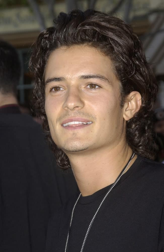 Actor Orlando Bloom attended the world premiere of his new movie "Pirates of the Caribbean: The Curse of the Black Pearl" at Disneyland, California on June 28, 2003. He came in a casual black shirt with his long tousled curly hairstyle.