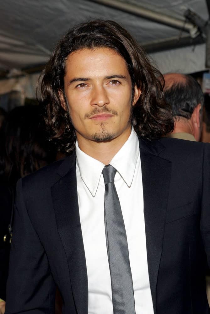 Orlando Bloom sported a side-parted long curly hairstyle and classy black suit at the "Elizabethtown" Premiere, Loews Lincoln Square Theater in New York on October 10, 2005.