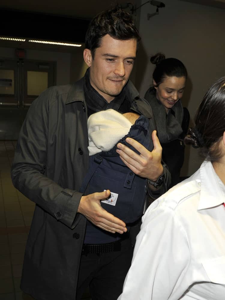 Actor Orlando Bloom was sporting a curly brushed up fade hairstyle with Miranda Kerr and their baby at LAX airport on March 5, 2010 in Los Angeles, California.