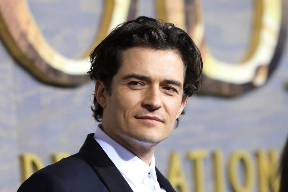 Orlando Bloom was at the premiere of Warner Bros' 'The Hobbit: The Desolation of Smaug' at the Dolby Theater on December 2, 2013 in Los Angeles, CA. He wore a dapper suit to balance his messy long curly hair that is perfectly tousled.