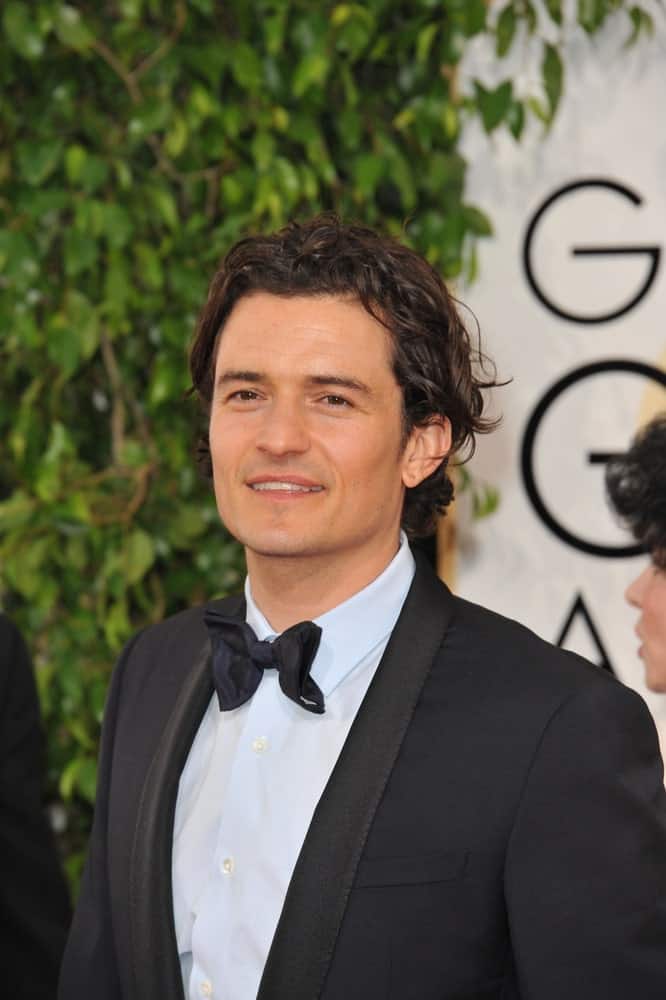 On January 12, 2014, Orlando Bloom attended the 71st Annual Golden Globe Awards at the Beverly Hilton Hotel. He went in his classy black tux and styled his long curly hair to be slick yet messy.