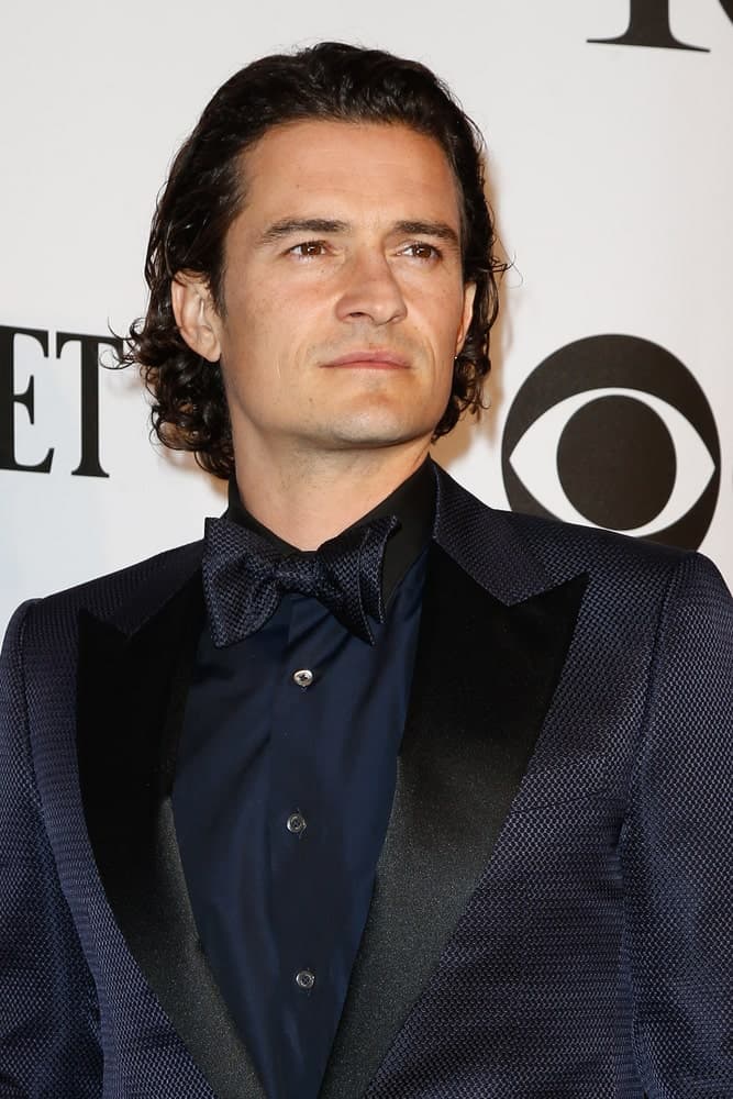 Actor Orlando Bloom sported a slicked back long and curly hairstyle when he attended the American Theatre Wing's 68th Annual Tony Awards at Radio City Music Hall on June 8, 2014 in New York City.
